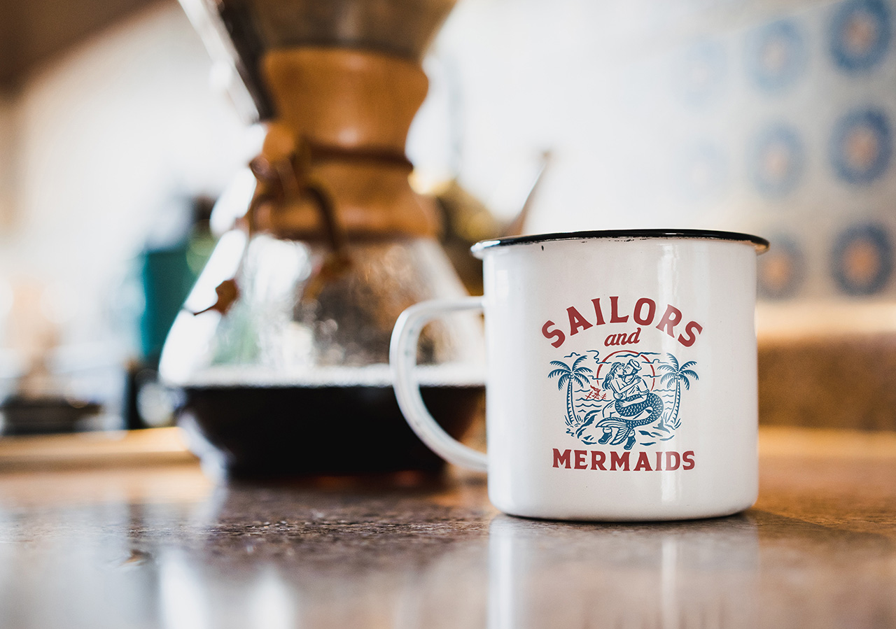 Coffee mug with the Sailors & Mermaids decal on it
